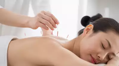 User receiving acupuncture therapy